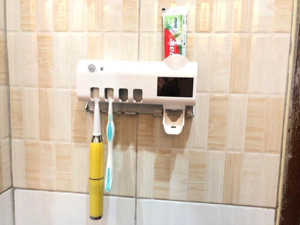 Toothpaste dispenser,sterilizer and toothbrush holder